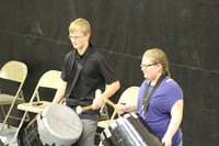 Two junior high band students playing drums
