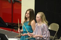 Two junior high band students playing drums