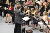 The junior high band director getting the band ready to play