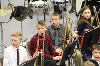 A group of students waiting to play in a band concert