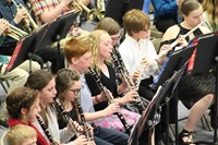 A group of intermediate students performing in a band concert