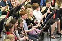 Intermediate school band students playing in a band concert