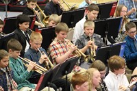 Intermediate school band students playing in a band concert