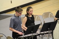 Intermediate school band students performing