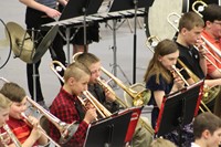 A group of intermediate students performing in a band concert