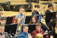 A group of intermediate students performing in a band concert
