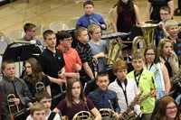 A group of intermediate school students after a band concert