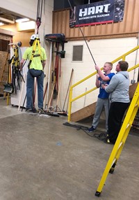 Junior high students learning to hoist another student