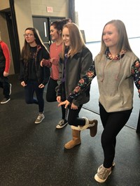 A group of junior high girls participating in an activity at a career day